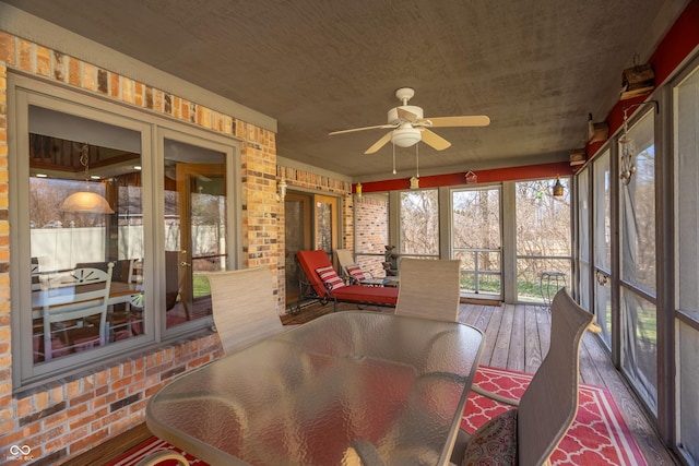 sunroom / solarium featuring ceiling fan