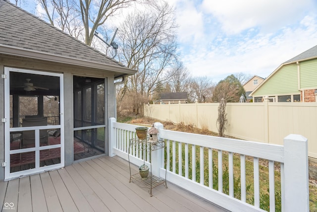 wooden deck with a sunroom