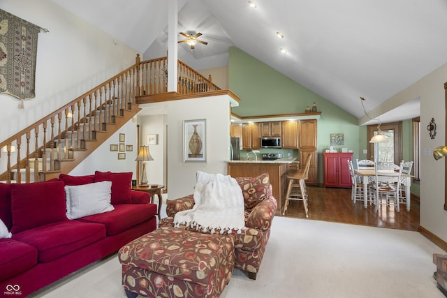 living room featuring wood-type flooring, high vaulted ceiling, and ceiling fan