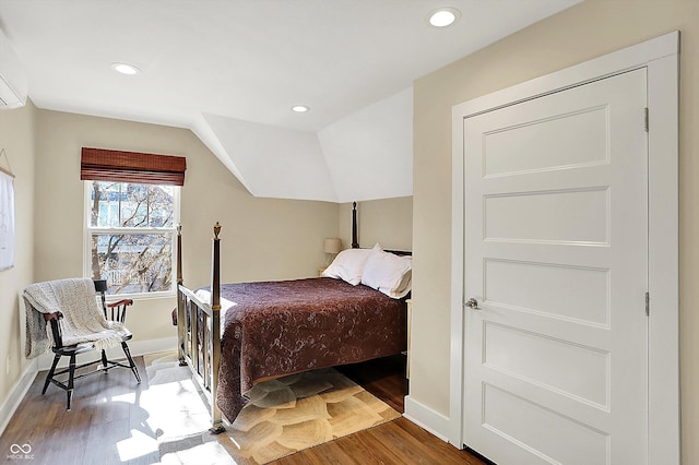 bedroom with hardwood / wood-style flooring and lofted ceiling