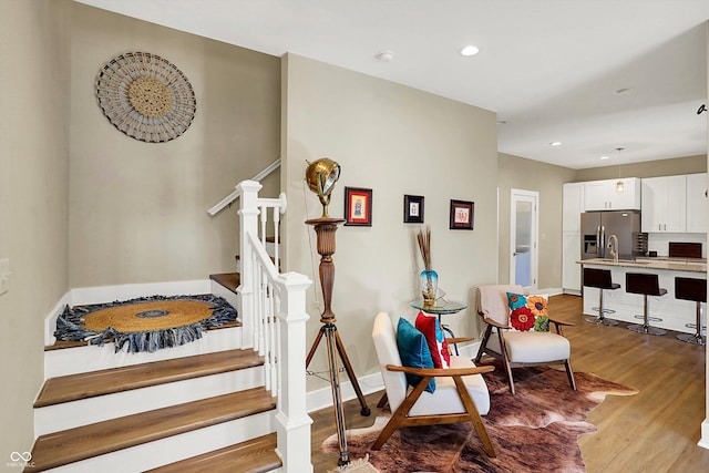 staircase with hardwood / wood-style flooring