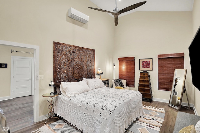 bedroom featuring dark wood-type flooring, ceiling fan, high vaulted ceiling, and an AC wall unit