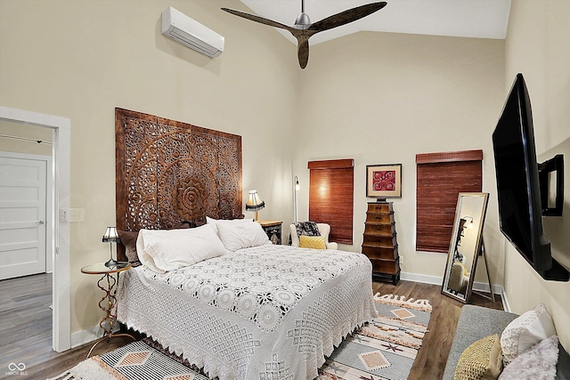 bedroom featuring a wall mounted air conditioner, dark wood-type flooring, high vaulted ceiling, and ceiling fan