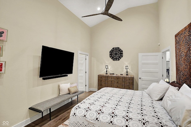 bedroom featuring hardwood / wood-style flooring, high vaulted ceiling, and ceiling fan