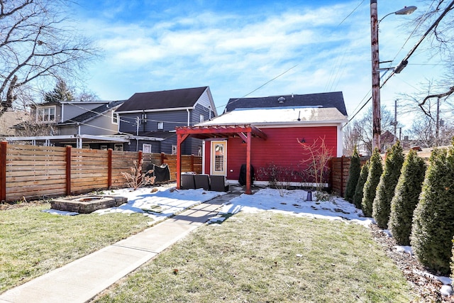 rear view of property with a pergola and a lawn