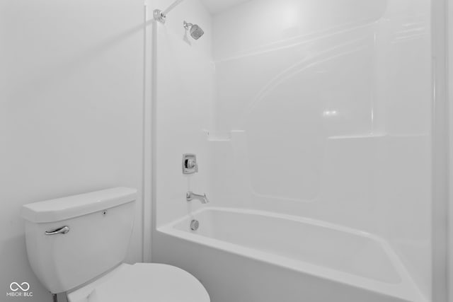 bathroom with shower / bathing tub combination and toilet