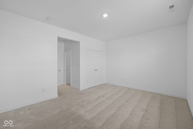 spare room with light colored carpet