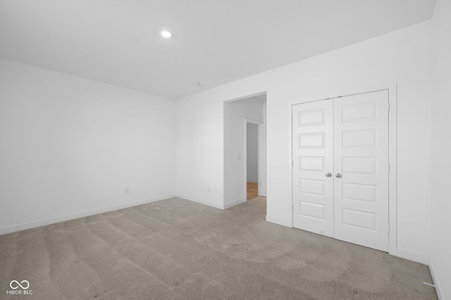 empty room featuring light carpet