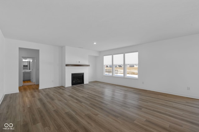 unfurnished living room with dark hardwood / wood-style flooring