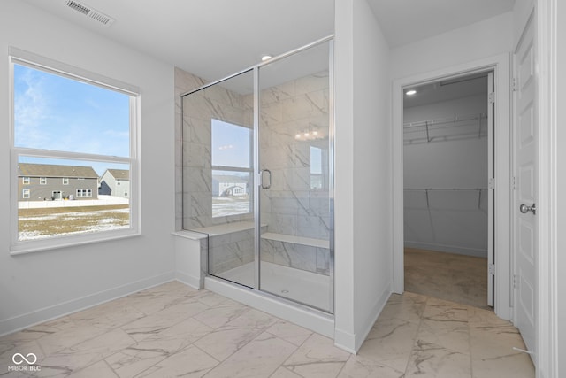 bathroom featuring a shower with door