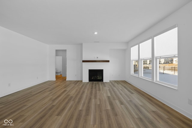 unfurnished living room featuring hardwood / wood-style flooring