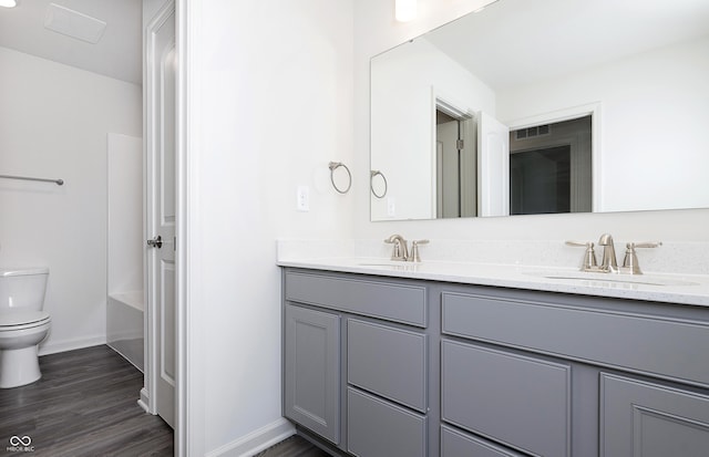 bathroom featuring vanity, toilet, and wood-type flooring