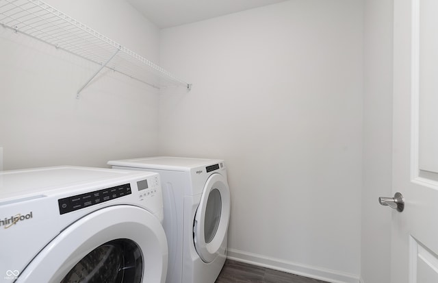 washroom featuring dark wood-type flooring and washer and clothes dryer