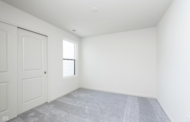 unfurnished bedroom with light carpet