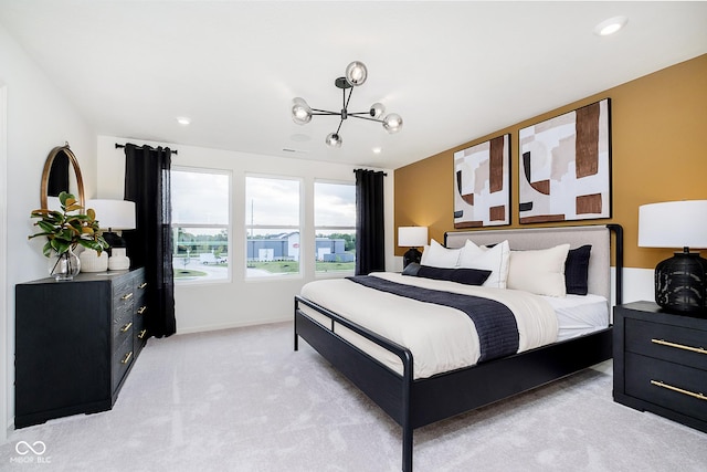 bedroom with an inviting chandelier and light carpet