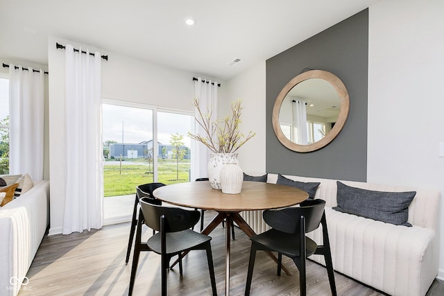 dining space featuring wood-type flooring