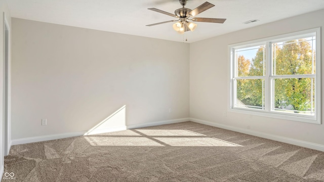 spare room featuring ceiling fan and carpet floors