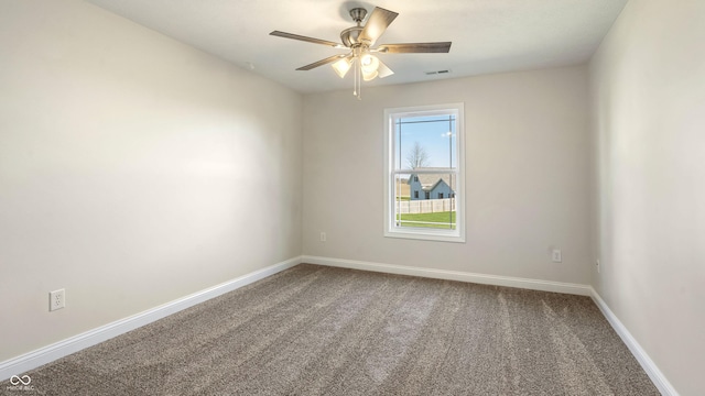 carpeted spare room with ceiling fan