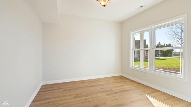 unfurnished room with a healthy amount of sunlight and light wood-type flooring