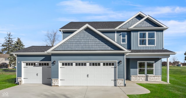 craftsman house featuring a garage and a front yard