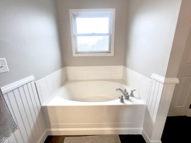 bathroom featuring a tub to relax in