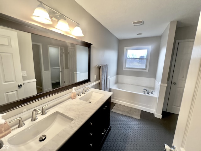 bathroom featuring tile patterned floors, vanity, and a bathtub