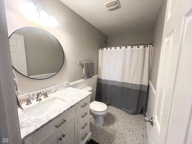 bathroom with vanity, a shower with curtain, tile patterned floors, and toilet