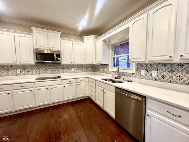 kitchen with sink, appliances with stainless steel finishes, dark hardwood / wood-style floors, decorative backsplash, and white cabinets