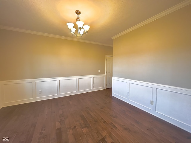 unfurnished room featuring ornamental molding, dark hardwood / wood-style floors, and a chandelier