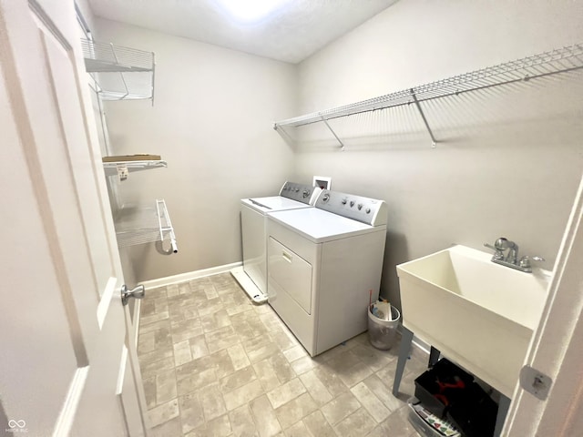 laundry area featuring separate washer and dryer and sink