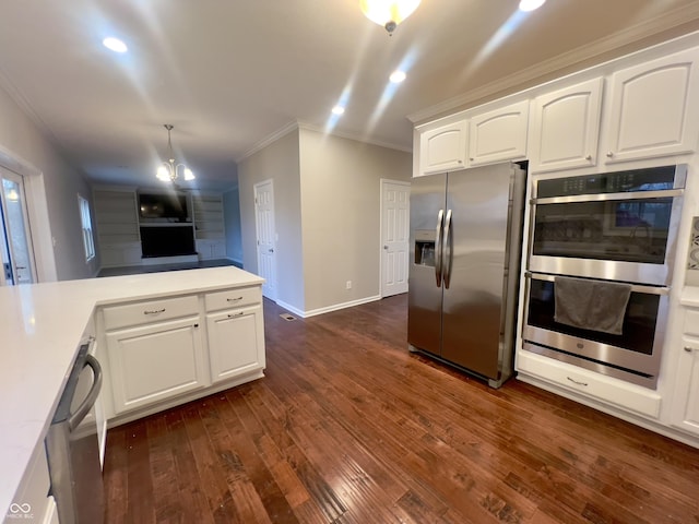 kitchen with appliances with stainless steel finishes, decorative light fixtures, white cabinetry, dark hardwood / wood-style flooring, and ornamental molding