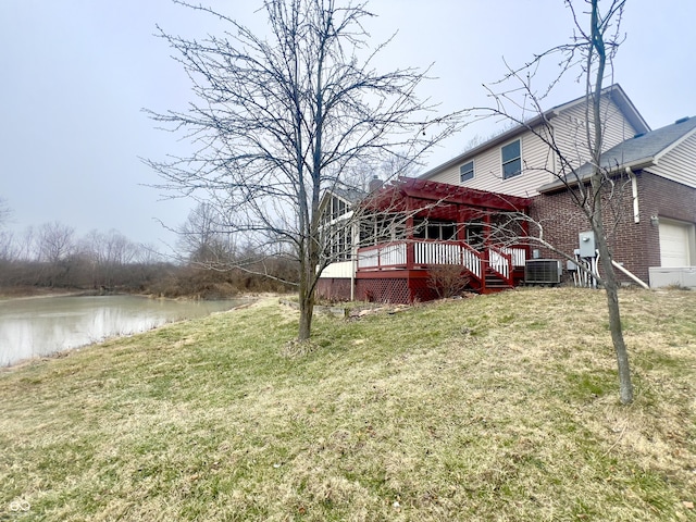 view of yard with a deck with water view and central AC