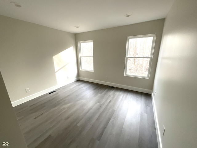 empty room featuring dark hardwood / wood-style flooring