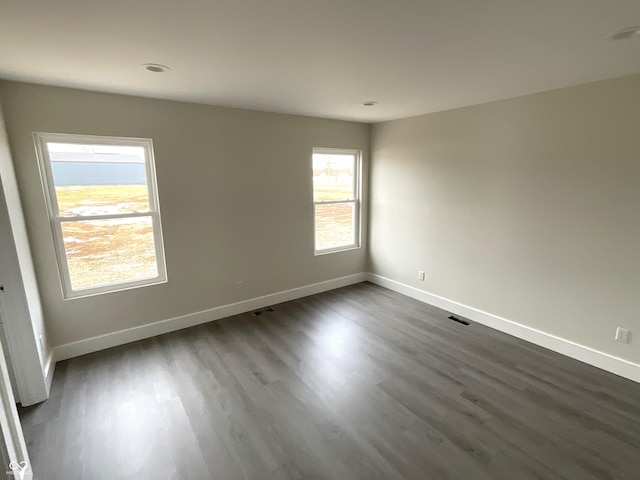 empty room featuring dark hardwood / wood-style flooring