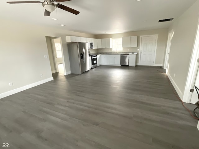 unfurnished living room with ceiling fan and dark hardwood / wood-style floors