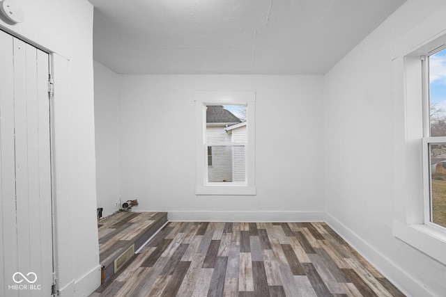 spare room with dark wood-type flooring