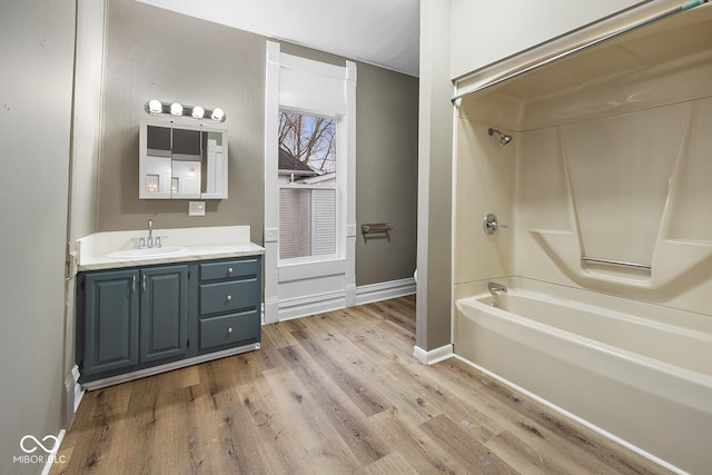 bathroom featuring vanity, hardwood / wood-style flooring, and  shower combination