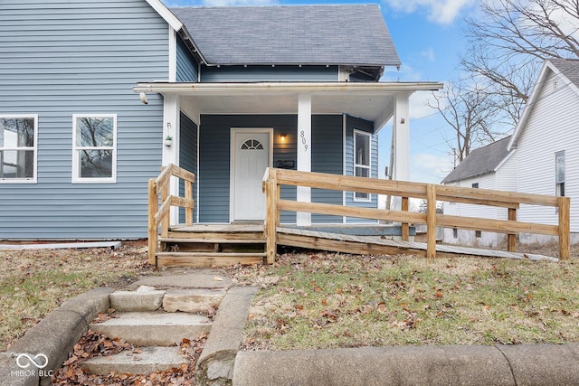 view of exterior entry with covered porch