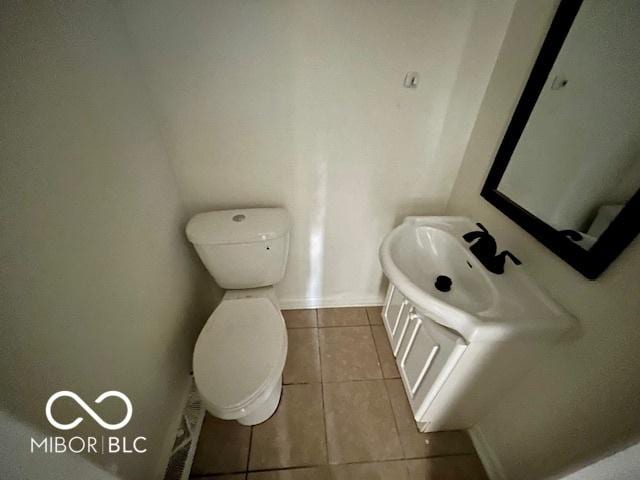 bathroom with tile patterned flooring, vanity, and toilet