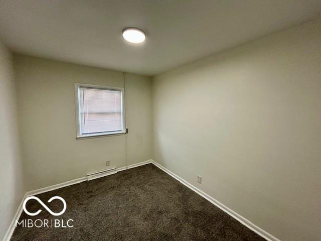 unfurnished room featuring a baseboard radiator and carpet floors