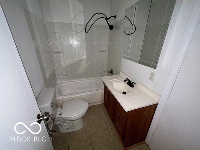 full bathroom featuring tile patterned flooring, vanity, tub / shower combination, and toilet