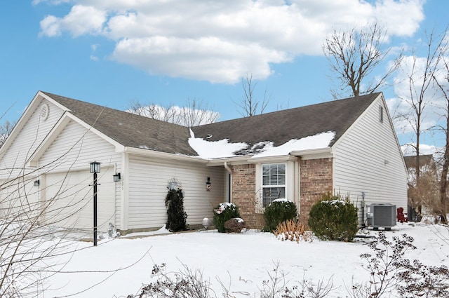 ranch-style home with brick siding and central air condition unit