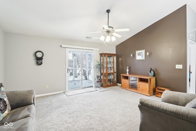 living area with lofted ceiling, ceiling fan, baseboards, and light colored carpet