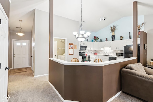 kitchen with pendant lighting, light countertops, white cabinetry, a peninsula, and black appliances