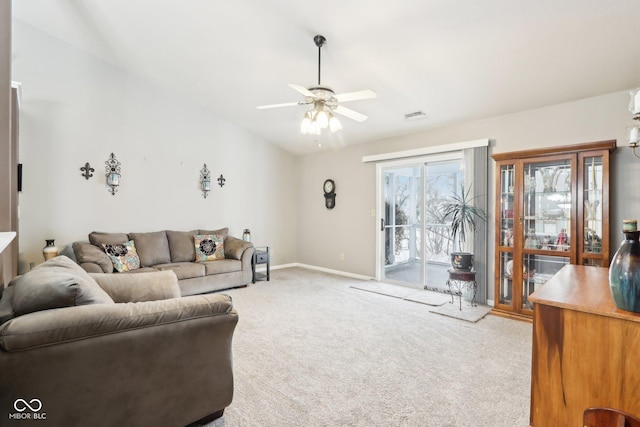 living area featuring ceiling fan, light carpet, visible vents, baseboards, and vaulted ceiling