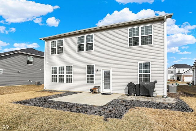 back of house with a lawn, cooling unit, and a patio area