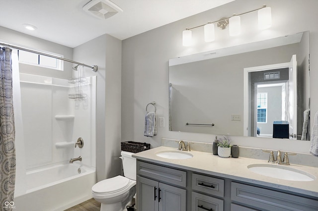 full bathroom featuring vanity, shower / bathtub combination with curtain, and toilet