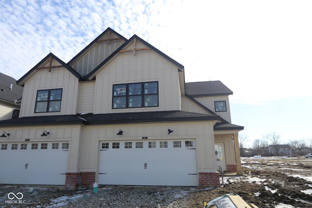 view of front of house featuring a garage, driveway, roof with shingles, board and batten siding, and brick siding