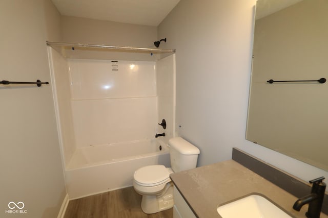 full bath with vanity, bathtub / shower combination, wood finished floors, and toilet