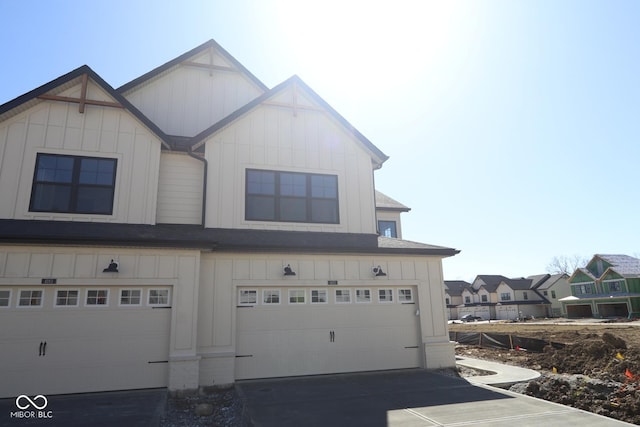 view of front of property featuring board and batten siding, concrete driveway, and a garage